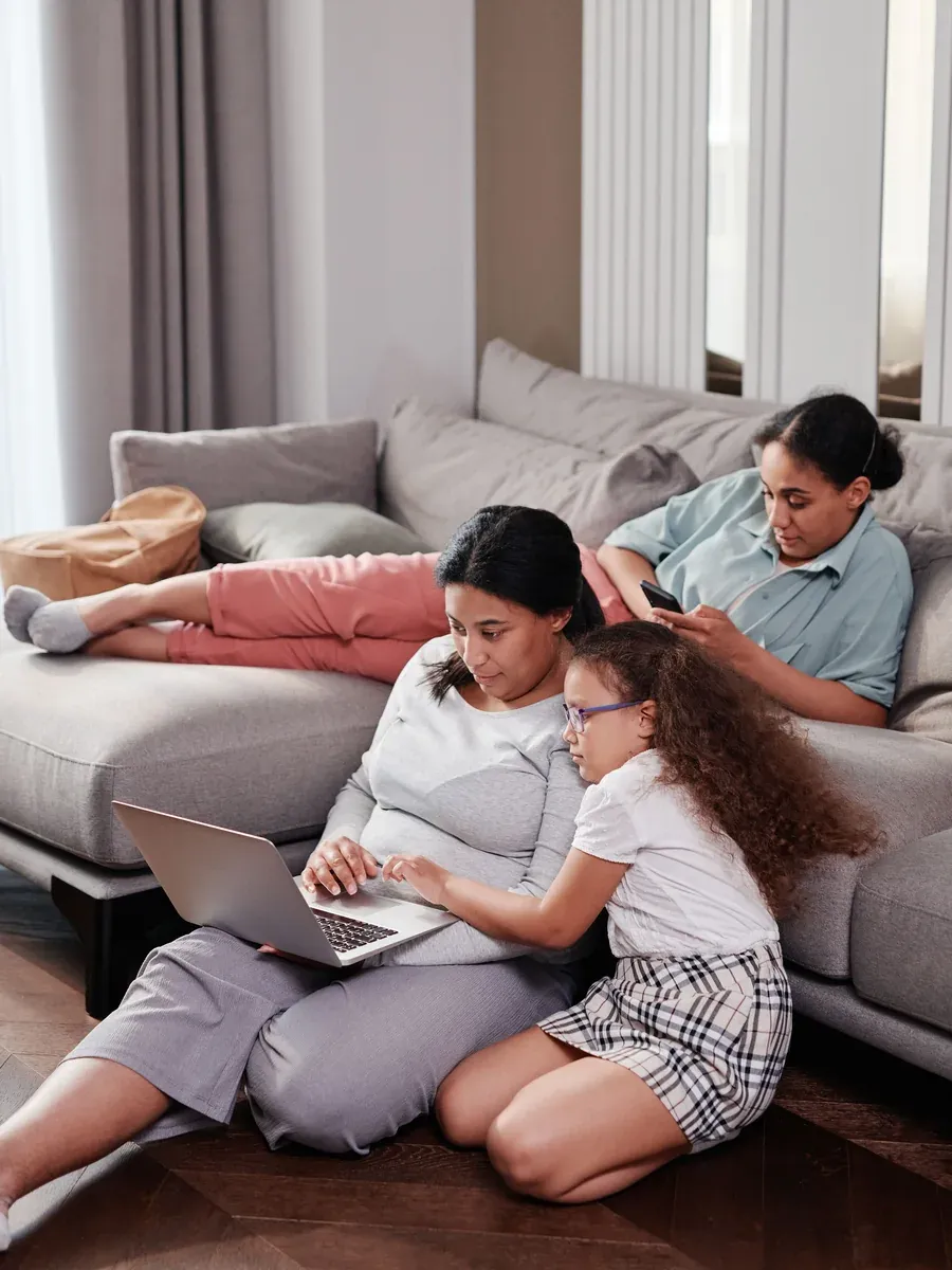Adult daughter and her mother looking at a laptop together